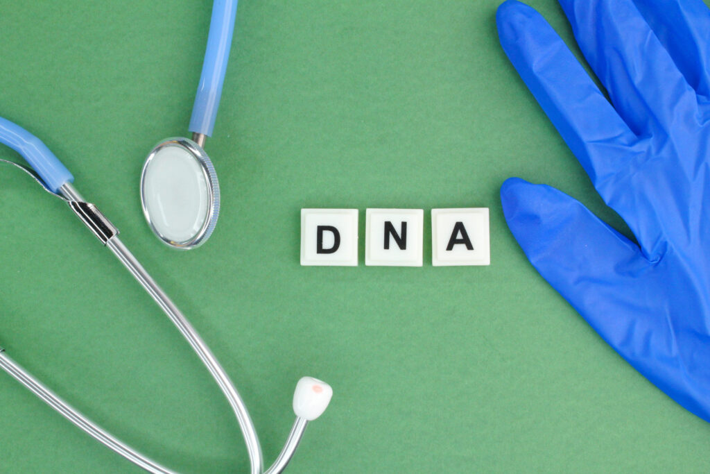 Stethoscope, gloves, and dna letters laying out
